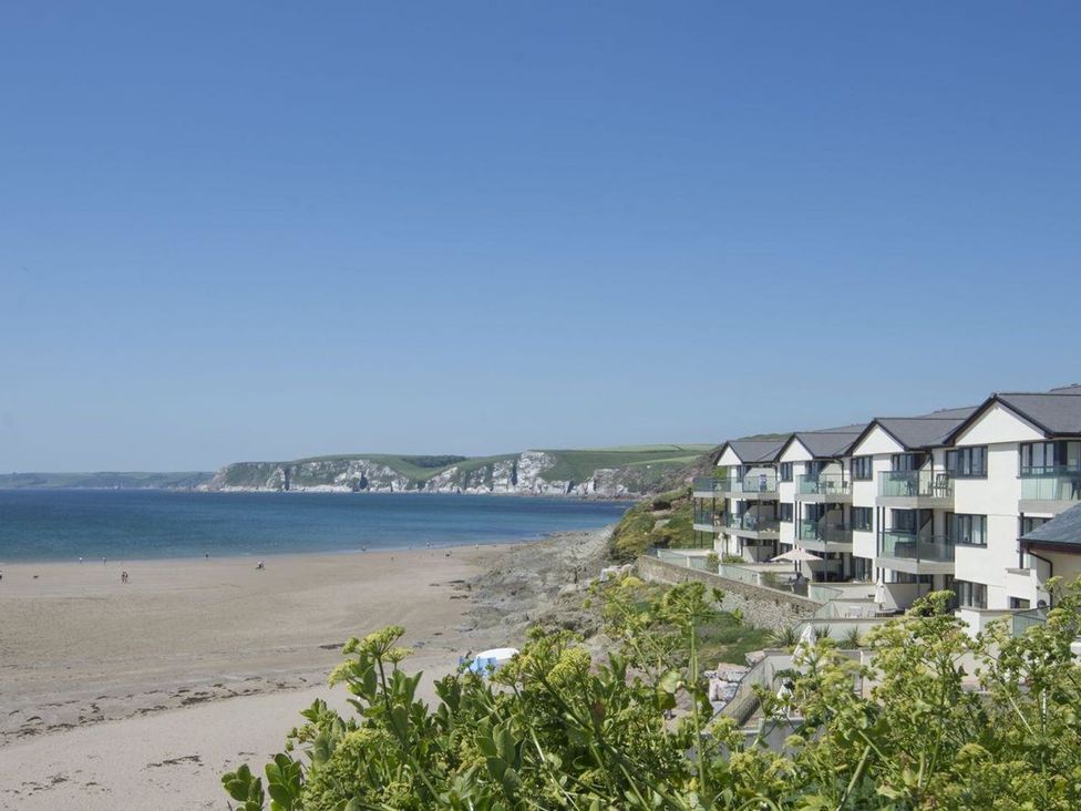 A view of a beach and apartment building at 2 Burgh Island Causeway Kingsbridge