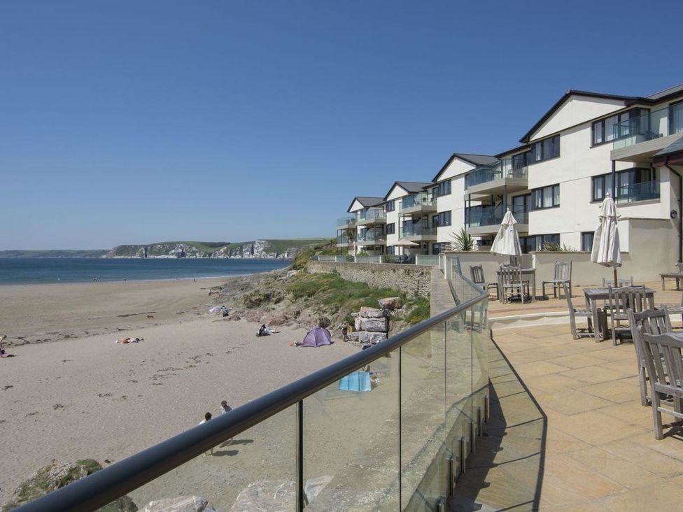 An outdoor area with tables and beach view at 2 Burgh Island Causeway in Kingsbridge