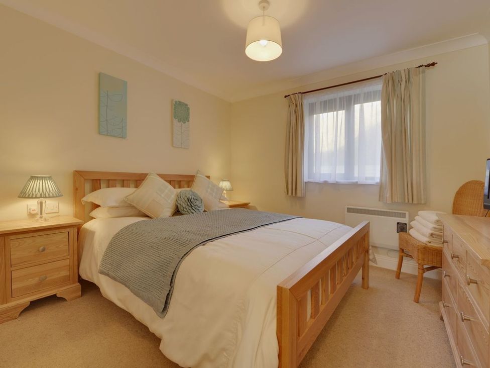 A bedroom with a bed and nightstand at 2 Burgh Island Causeway Kingsbridge