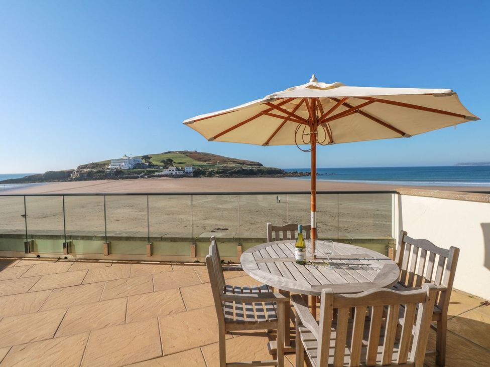 An outdoor terrace with a table and chairs at 2 Burgh Island Causeway in Kingsbridge