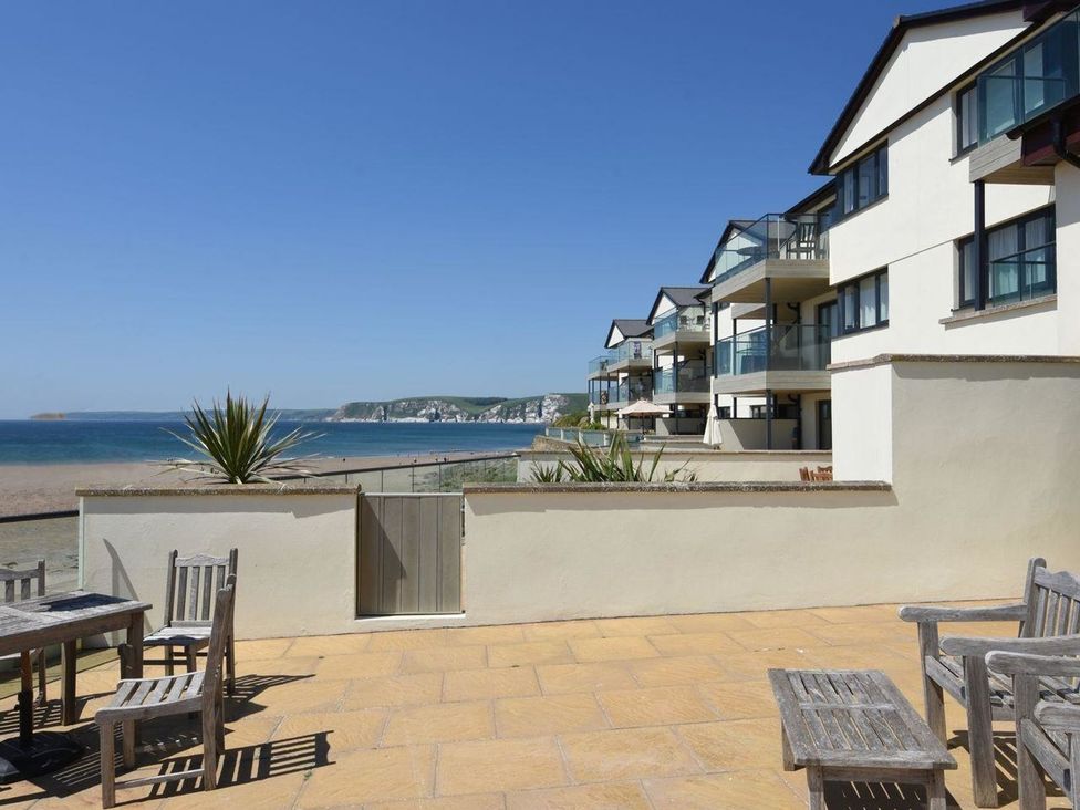 An outdoor area with tables overlooking the sea at 2 Burgh Island Causeway in Kingsbridge