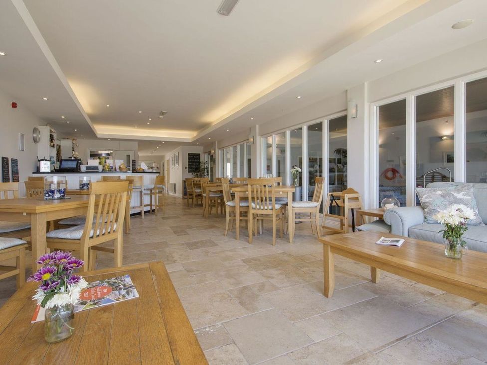 A dining room with tables and seating at 2 Burgh Island Causeway, Kingsbridge