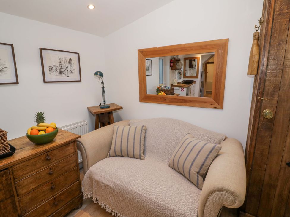 A living room with a sofa and a fruit bowl at Flat 4 in Evesham