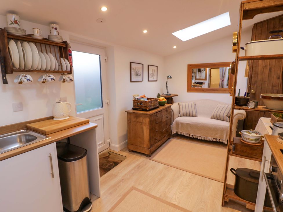 A kitchen with a sink a cabinet and a table at Flat 4 Evesham
