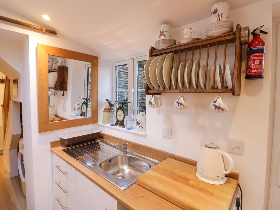 A kitchen with a sink and wooden countertop at Flat 4 Evesham