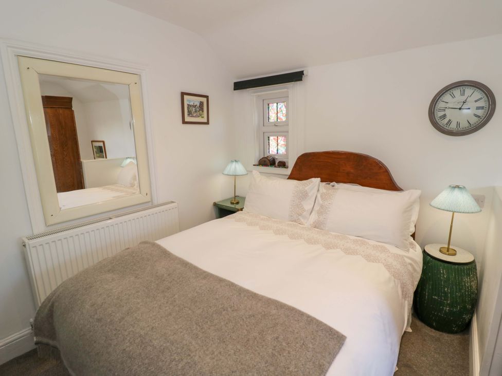 A bedroom with a bed and lamp at Flat 4 in Evesham