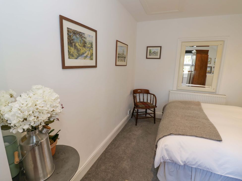 A bedroom with a bed and wall art at Flat 4 in Evesham