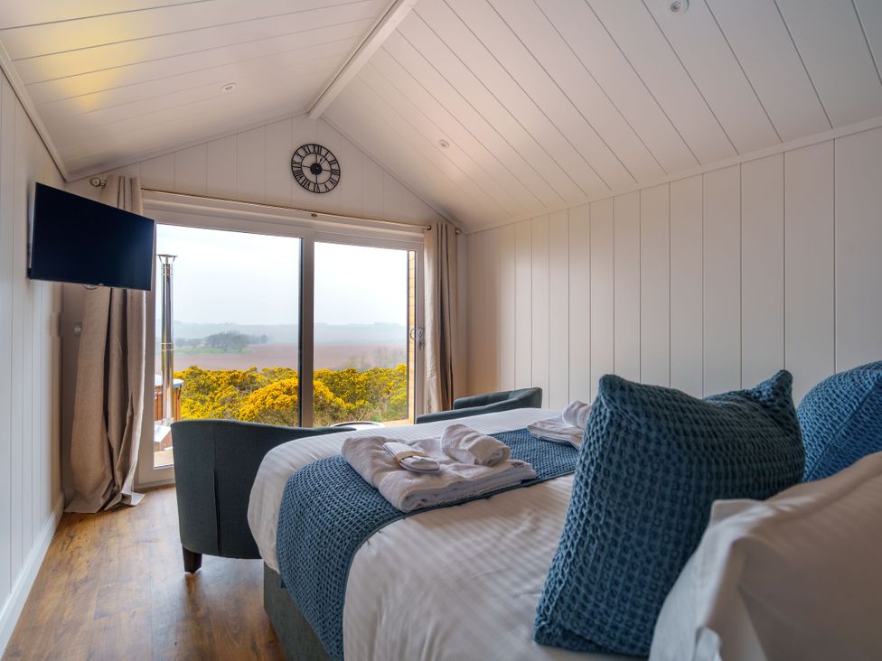 A bedroom with a bed and television at The Grays in North Berwick