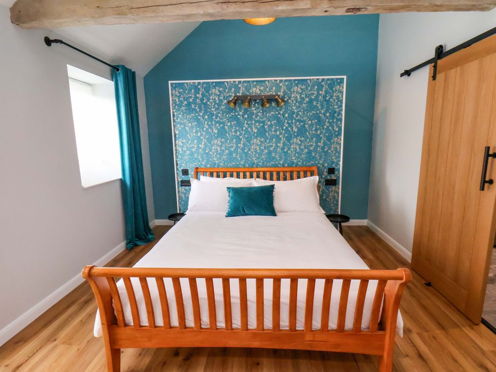 A bedroom with a bed and nightstand at The Homestead in Moorsholm