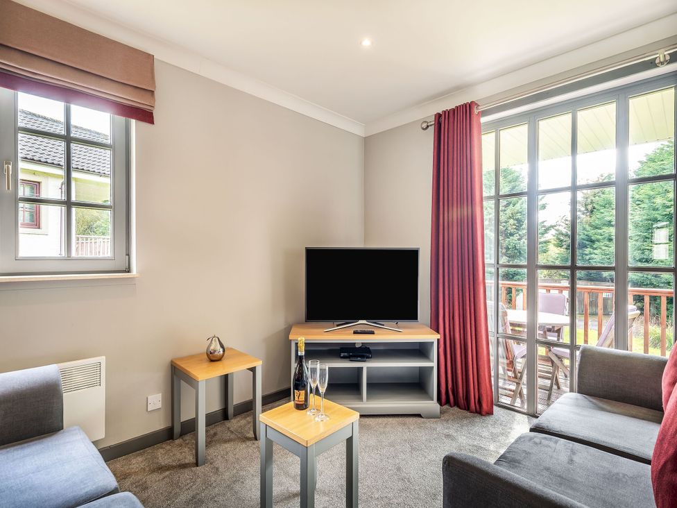 A living room with a television and sofa at Bargany (Pet) Dailly