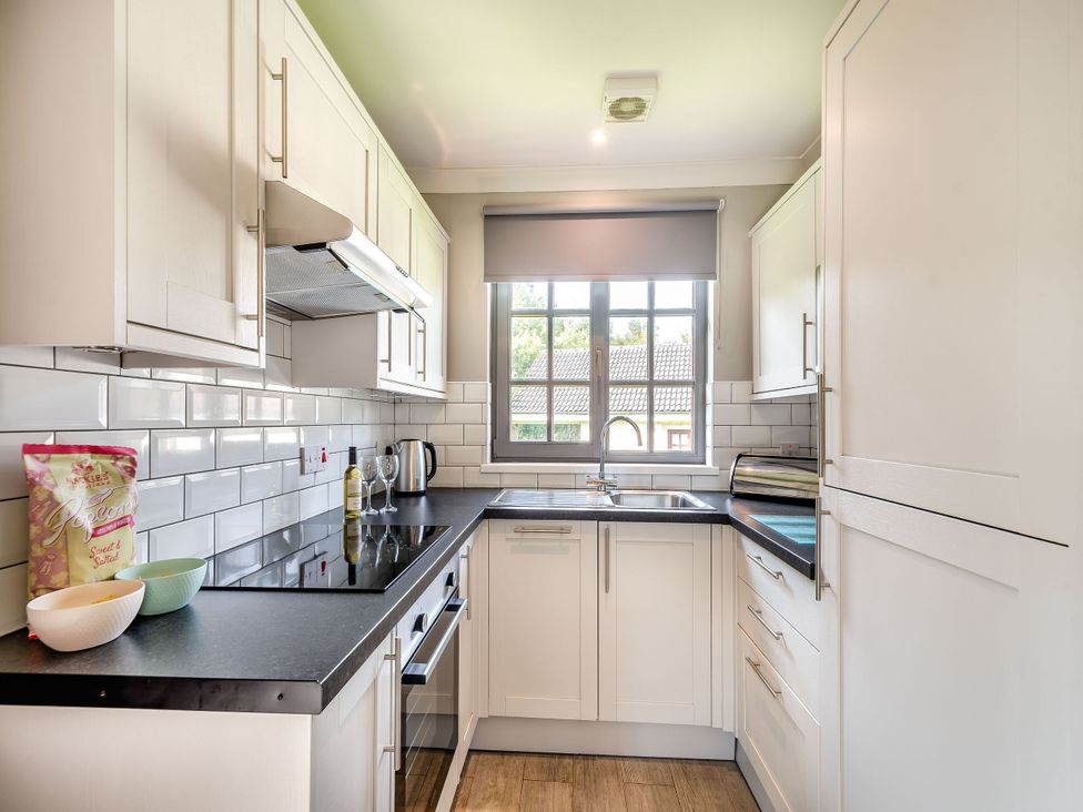 A kitchen with cabinets and a sink at Bargany (Pet) Dailly
