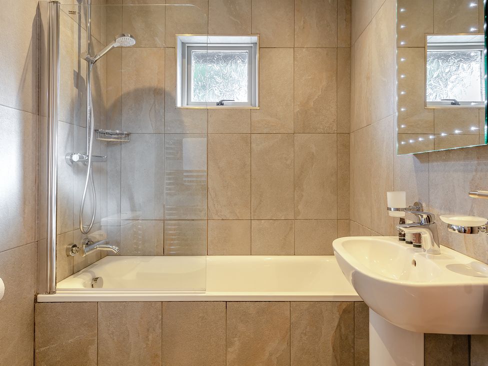 A bathroom with a bathtub and shower at 4C2 Summerleaze Garden Cottage 2 Spa Bude