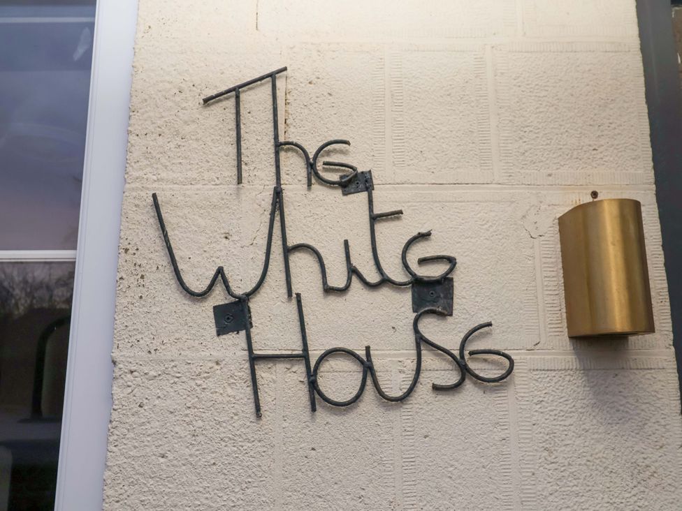 A sign on a wall that reads The White House at The White House in Norwich