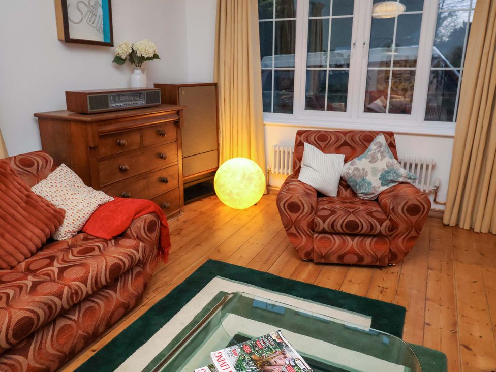 A living room with a sofa and armchair at The White House in Norwich