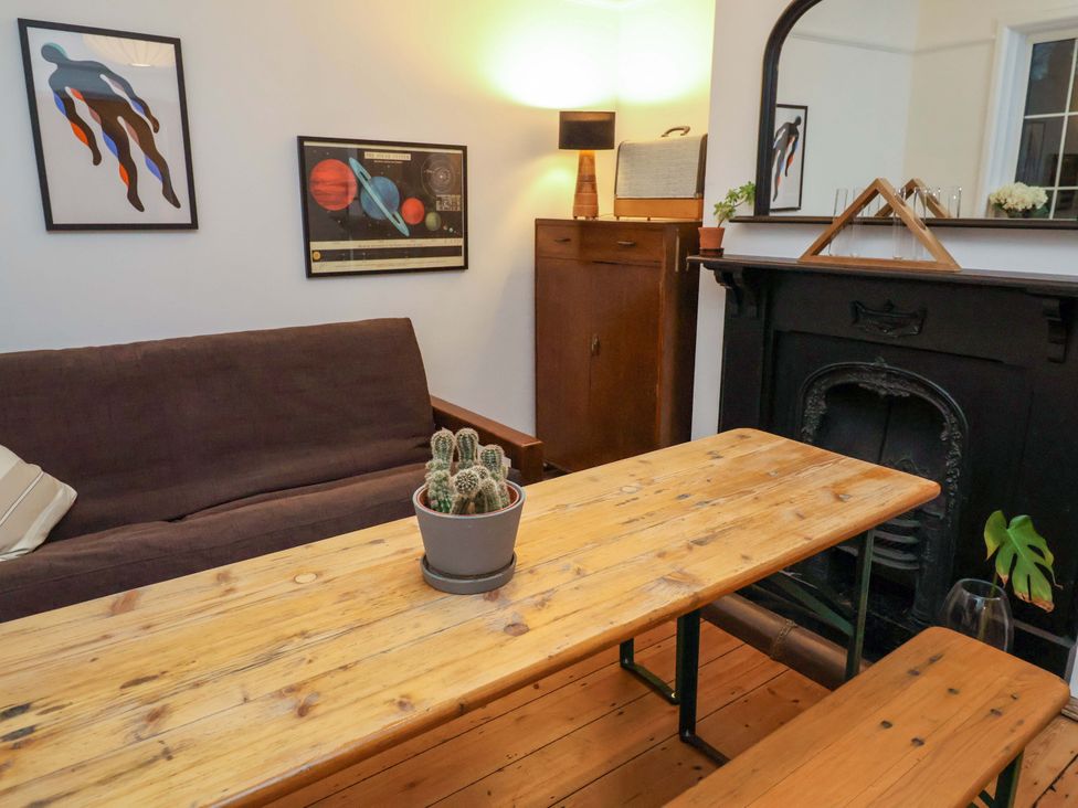 A living room with a sofa and wooden table at The White House in Norwich