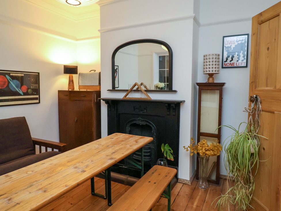 A dining room with a table and benches at The White House in Norwich