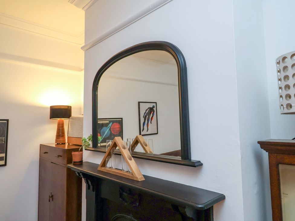 A living room featuring a mirror and artwork at The White House in Norwich