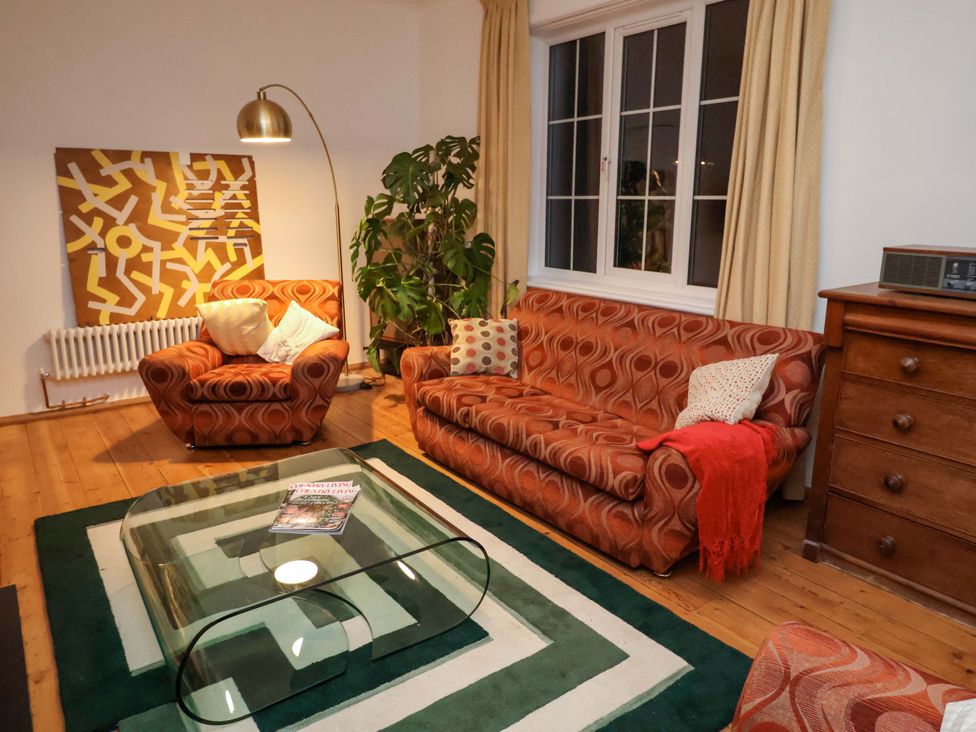 A living room with a sofa and coffee table at The White House in Norwich