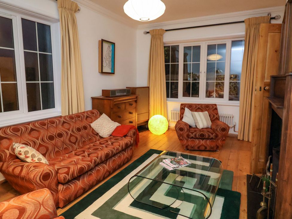 A living room with a sofa and armchair at The White House in Norwich