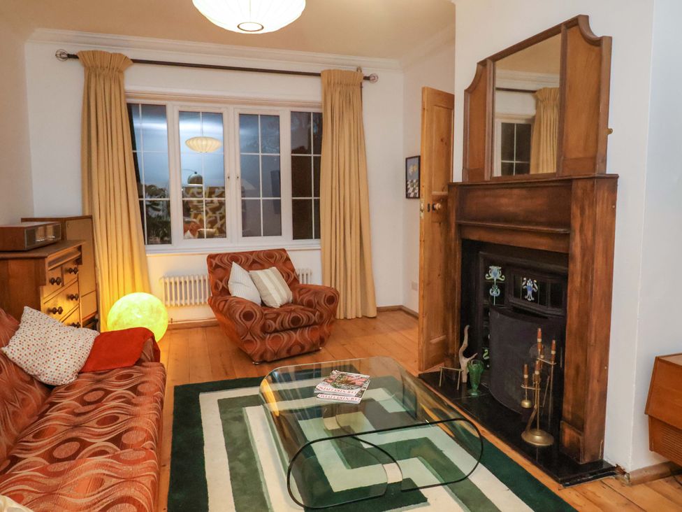 A living room with a sofa and armchair at The White House in Norwich