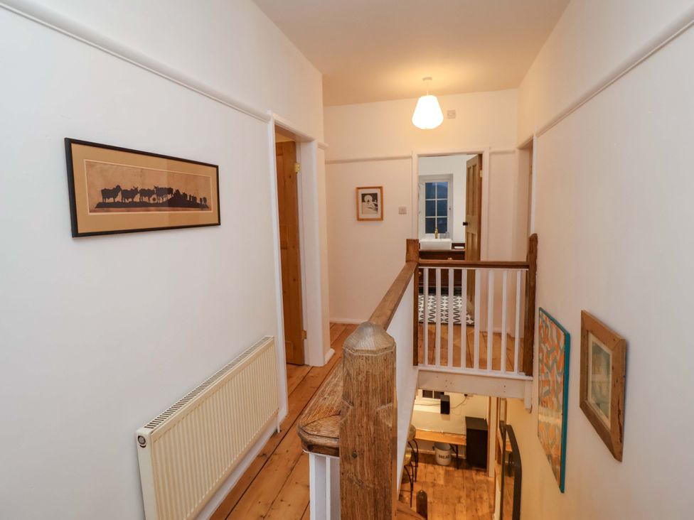 A hallway with doors and pictures on the wall at The White House in Norwich