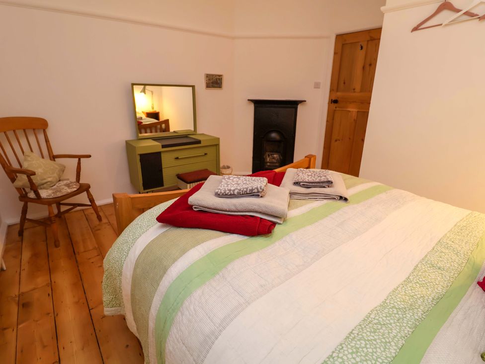 A bedroom with a bed and a dressing table at The White House in Norwich