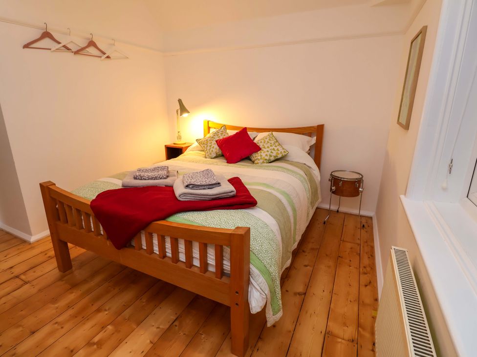 A bedroom with a bed and bedside lamp at The White House in Norwich