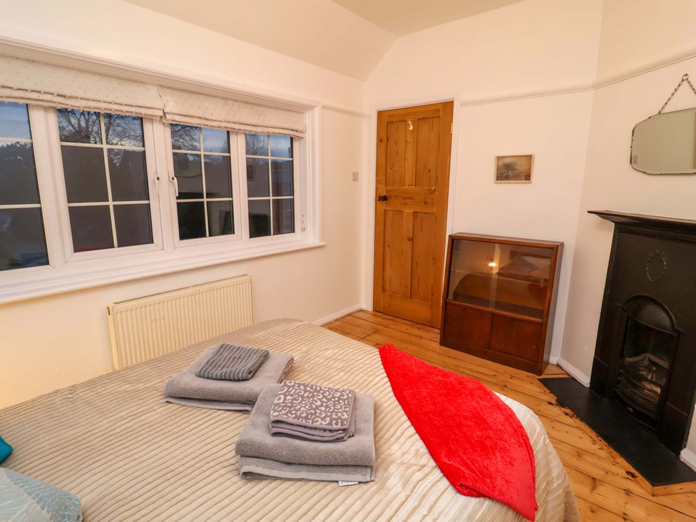 A bedroom with a bed and towels at The White House in Norwich