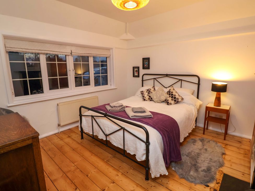 A bedroom with a bed and lamp at The White House in Norwich