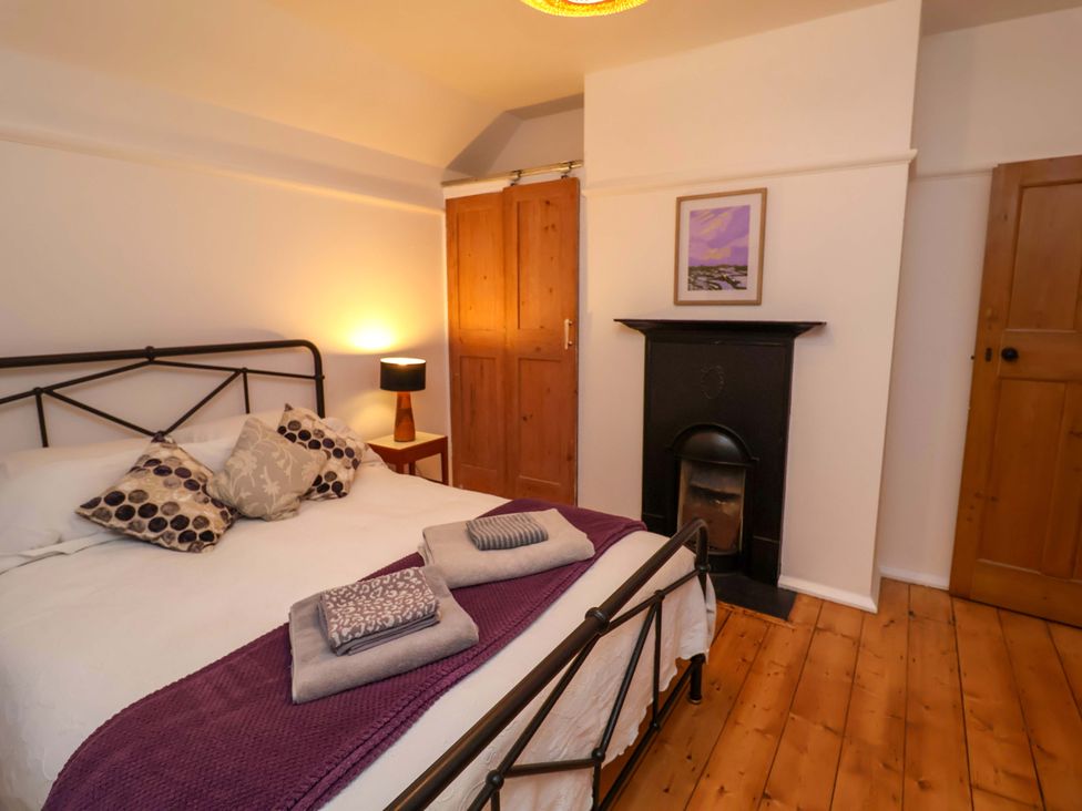 A bedroom with a bed and wardrobe at The White House in Norwich