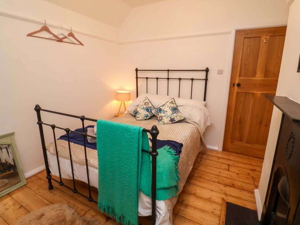 A bedroom with a bed and lamp at The White House in Norwich