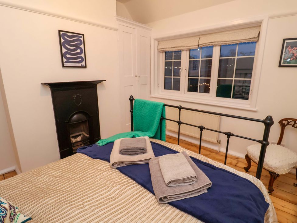 A bedroom with a bed and towels on it at The White House in Norwich