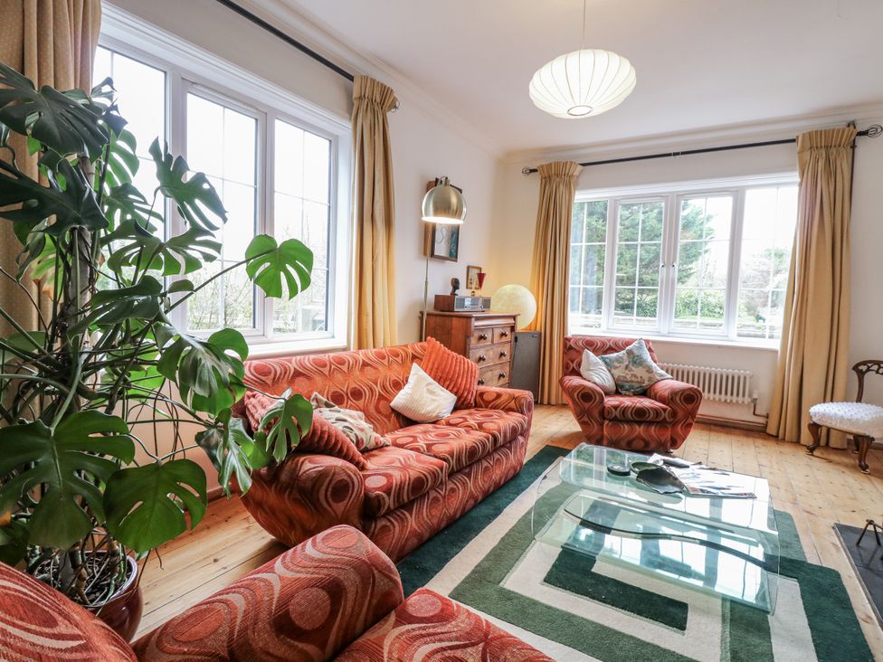 A living room with a sofa and armchair at The White House in Bracondale