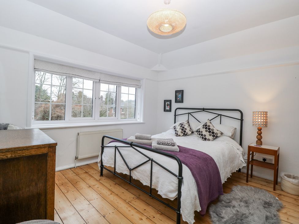 A bedroom with a bed and windows at The White House in Bracondale