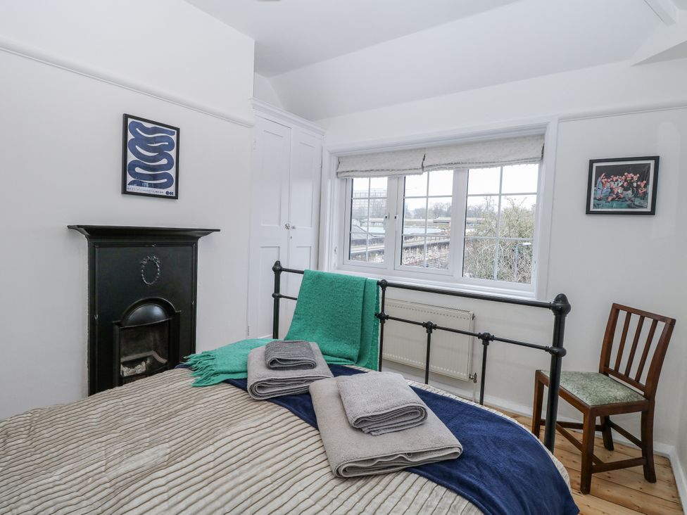 A bedroom with a bed and decorated wall at The White House in Bracondale