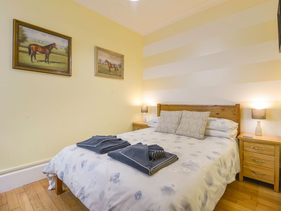 A bedroom with a bed and nightstands at The Old Signal House in Torpoint