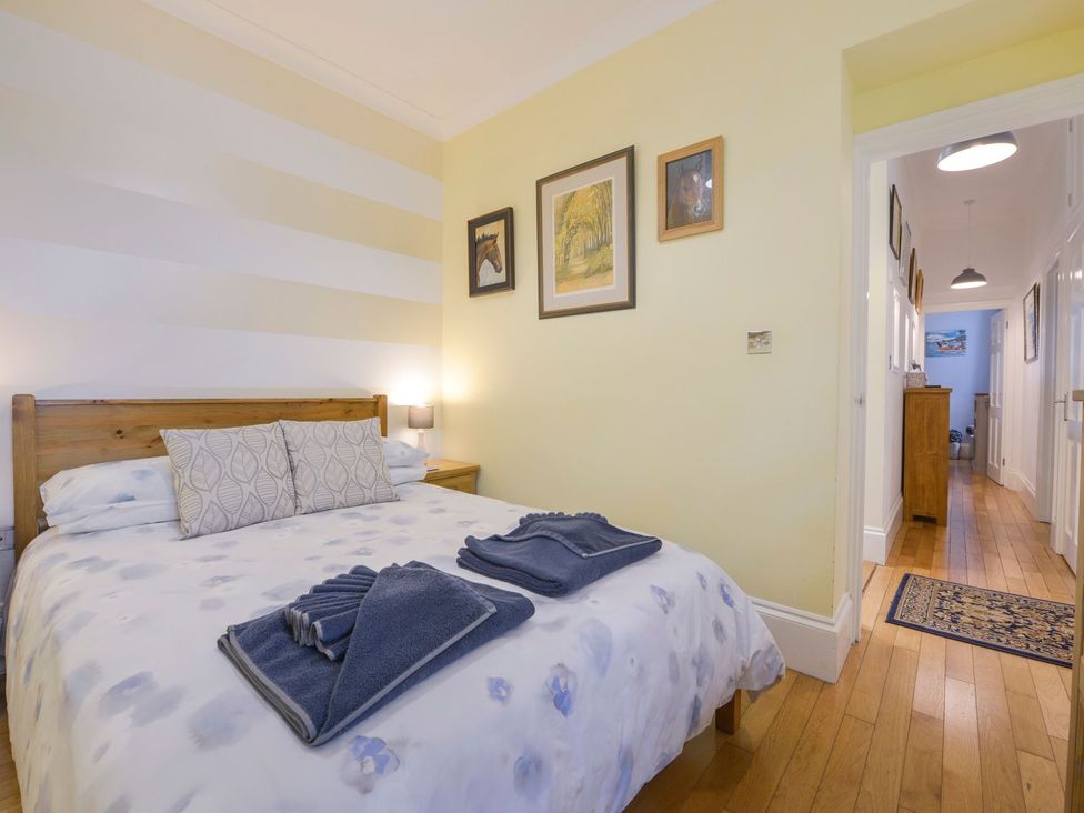 A bedroom with a bed and towels on the bed at The Old Signal House in Torpoint