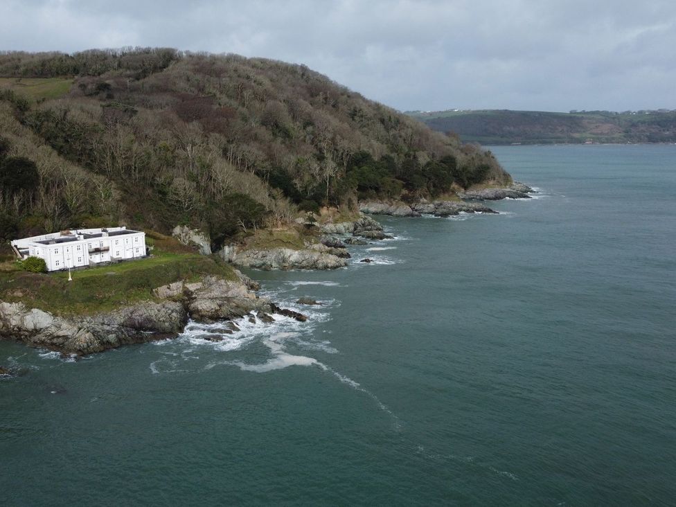 A house on rocky shore near water at The Old Signal House in Torpoint