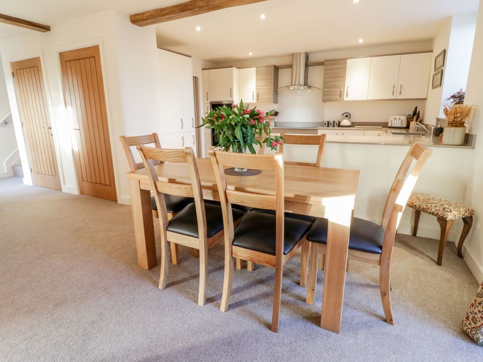 A dining area with a table and chairs at Grange Cottage in Crediton