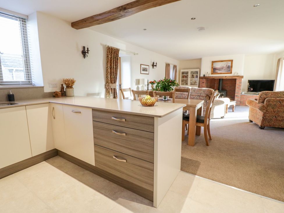 A kitchen with dining area and living space at Grange Cottage in Crediton