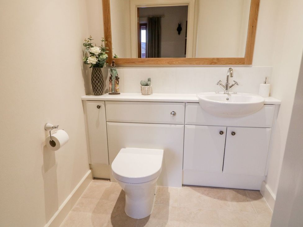 A bathroom with a toilet and sink at Grange Cottage in Crediton