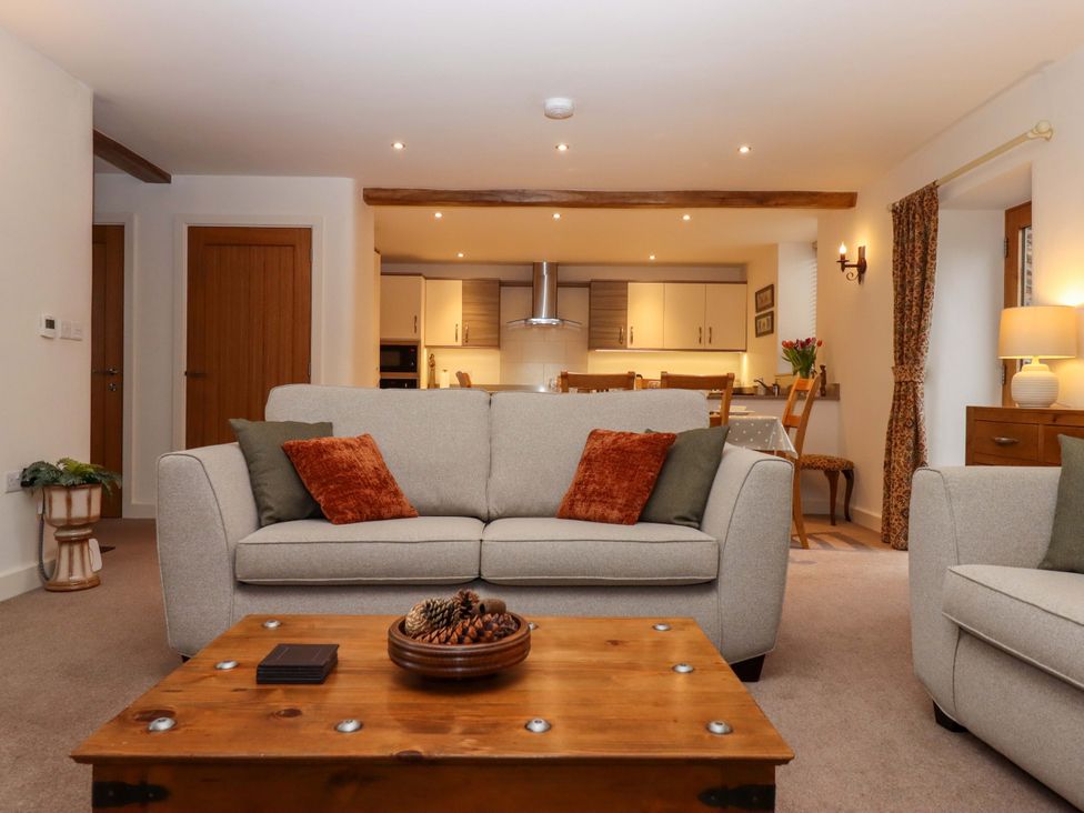 A living room with a sofa and coffee table at Grange Cottage in Coldridge