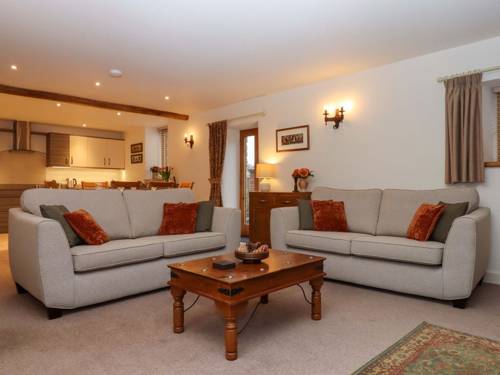 A living room with sofas and a coffee table at Grange Cottage in Coldridge