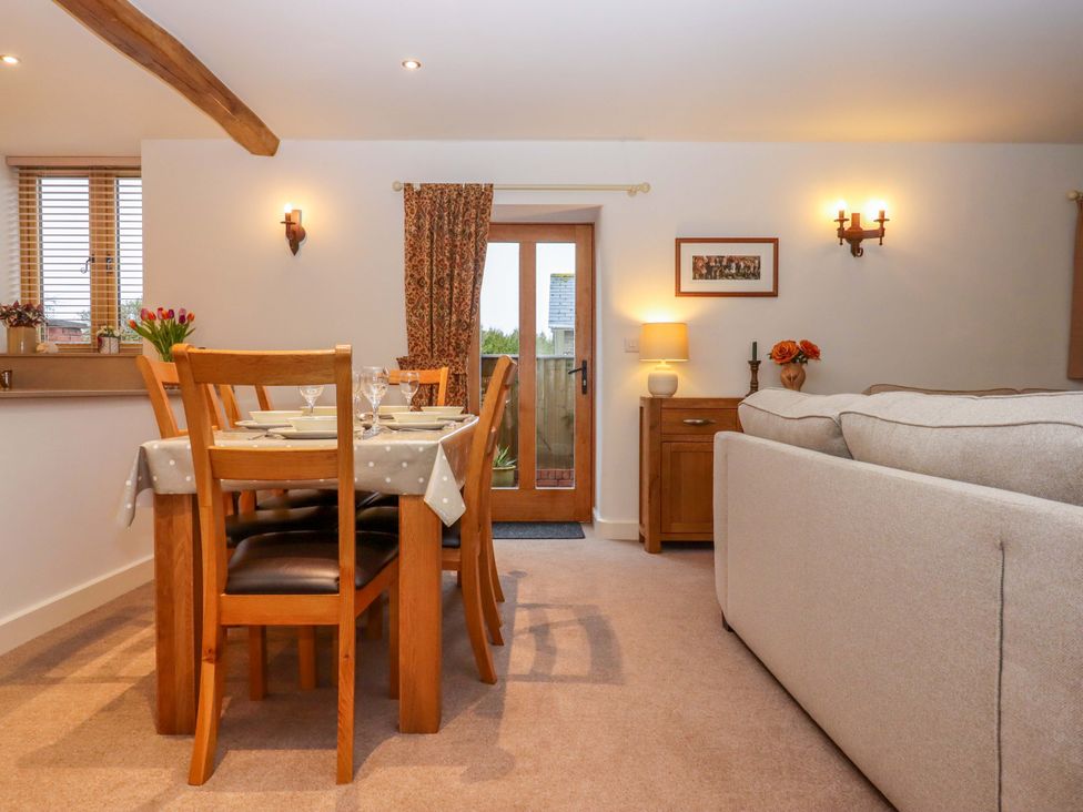 A dining room with a table and chairs at Grange Cottage in Coldridge