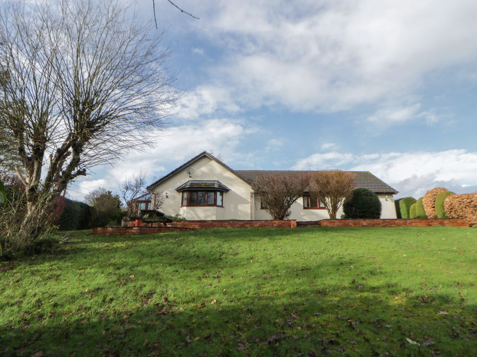A house with trees and garden in front at Summerhill in Hereford