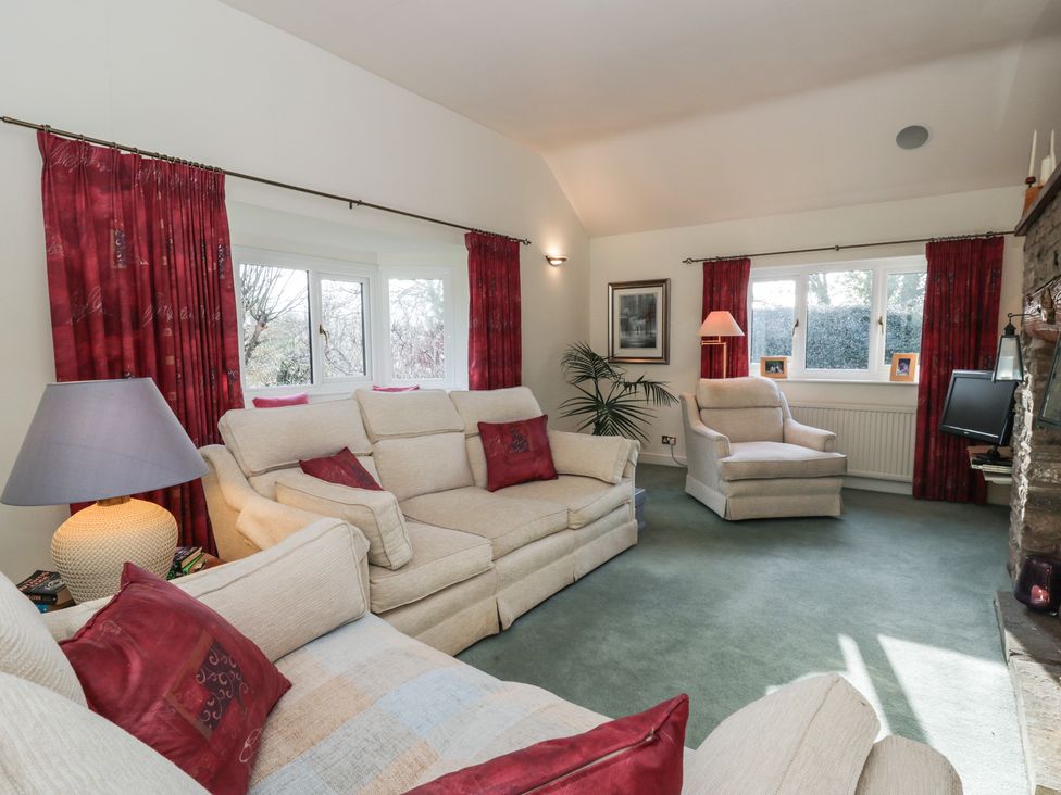 A living room with a sofa and armchair at Summerhill in Hereford