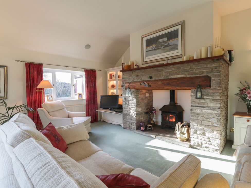 A living room with a fireplace and sofa at Summerhill in Hereford