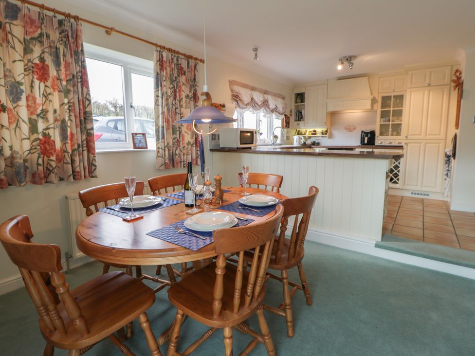 A dining room with a table and chairs at Summerhill in Hereford