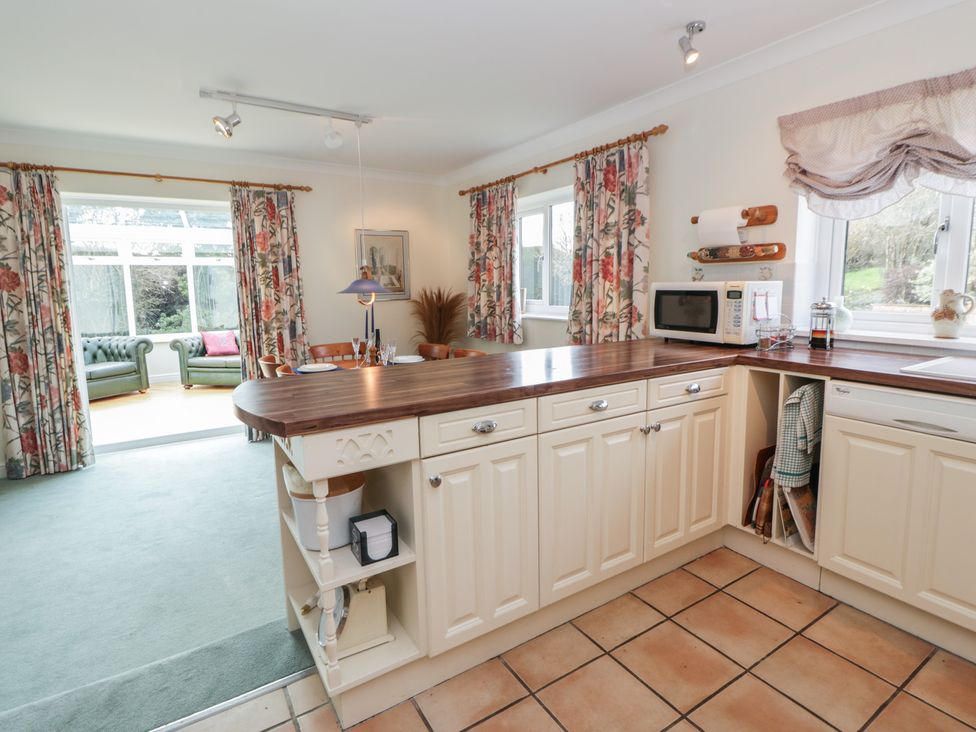 A kitchen with cabinets and a microwave at Summerhill Hereford