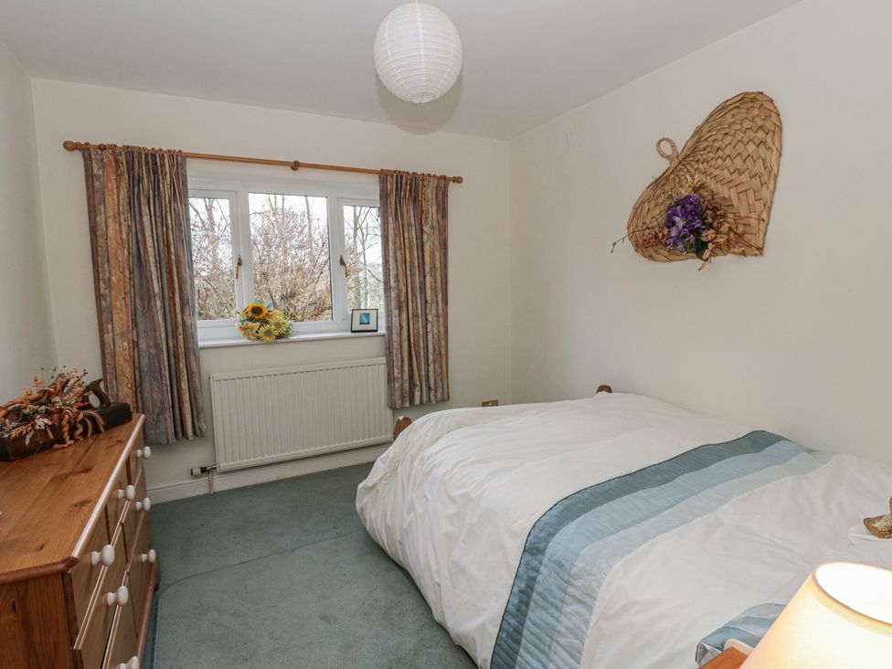 A bedroom with a bed and curtains at Summerhill in Hereford